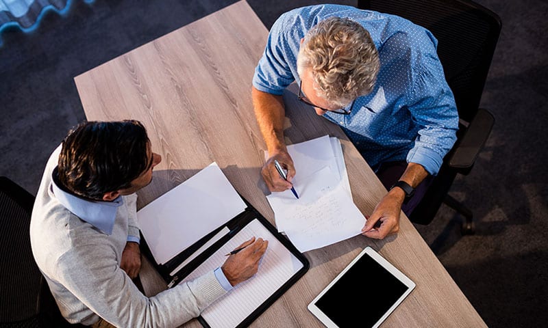 Two men reviewing paperwork