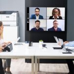 Xerox® B410 Printer in the workplace People in a meeting room in front of the Xerox® B410 printer