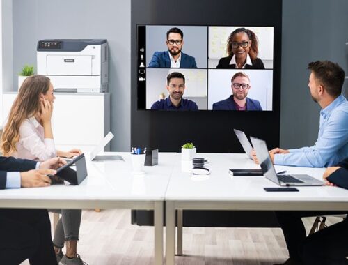 People in a meeting room in front of the Xerox® B410 printer