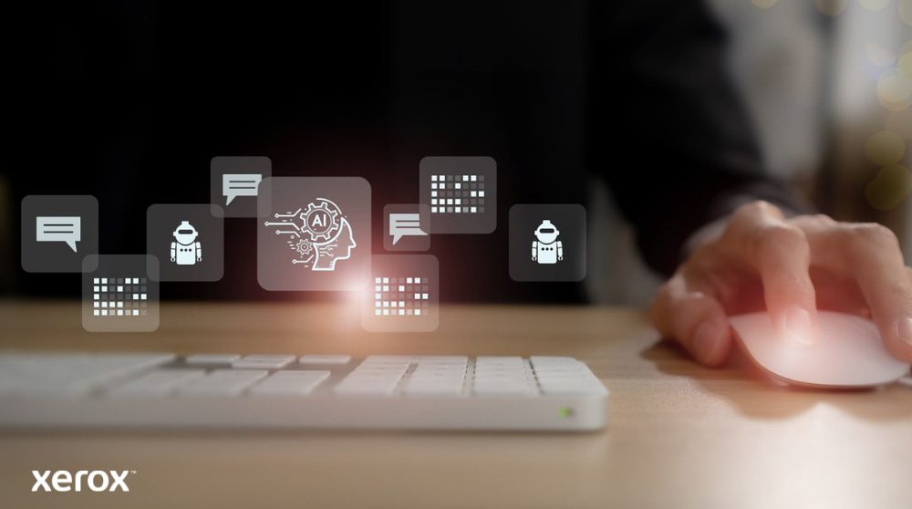 Xerox® DocuShare® Go: Intelligent Document Management A person's hand is on a computer mouse, with abstract glowing icons related to communication, AI, and data processing floating above the keyboard, representing intelligent document functionalities.