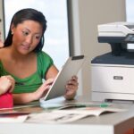 Two women using a tablet in front of a Xerox® VersaLink® B415 Multifunction Printer Two women using a tablet in front of a Xerox® VersaLink® B415 Multifunction Printer
